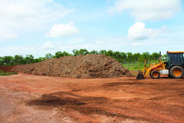 Tractor scooping up mulch